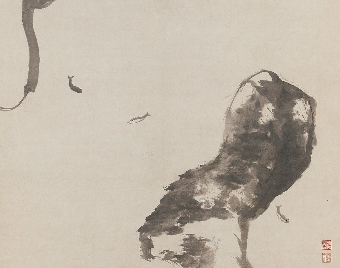 Detail of an ink hanging scroll by Bada Shanren: the lower edge of a hanging rock at the upper left, a large rock mass at the right, and three small fish suspended in a wide field of empty paper between them, each drawn in a handful of strokes. Two red seals sit in the lower right corner.