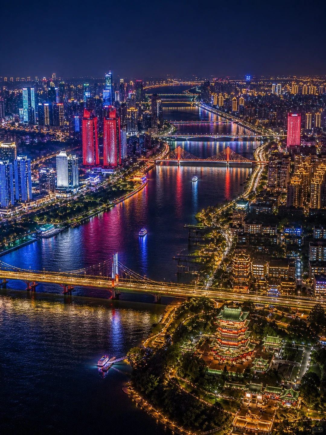 Aerial night view of Nanchang with the Gan River, lit bridges, the Honggutan skyline and Tengwang Pavilion