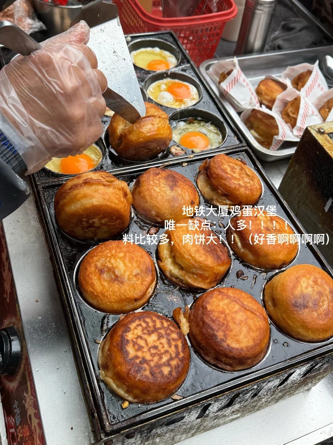 Egg burgers cooking in a cast-iron mould pan at a Nanchang street cart, eggs cracked into the wells