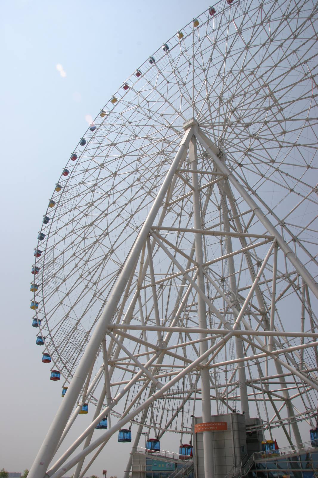 The Star of Nanchang, a 160-metre Ferris wheel on the west bank of the Gan River, seen from below — its white lattice ring hung with coloured gondolas