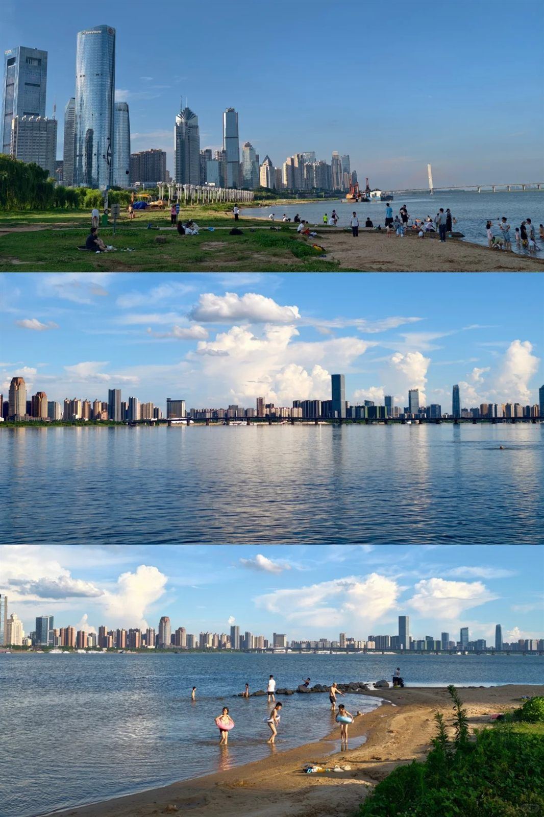 The Gan River riverfront in Nanchang by day: families on the grassy, sandy riverbank and people paddling at the water's edge, the Honggutan skyline across the river